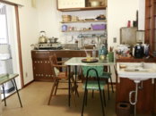 A retro kitchen with a dining table and sink.